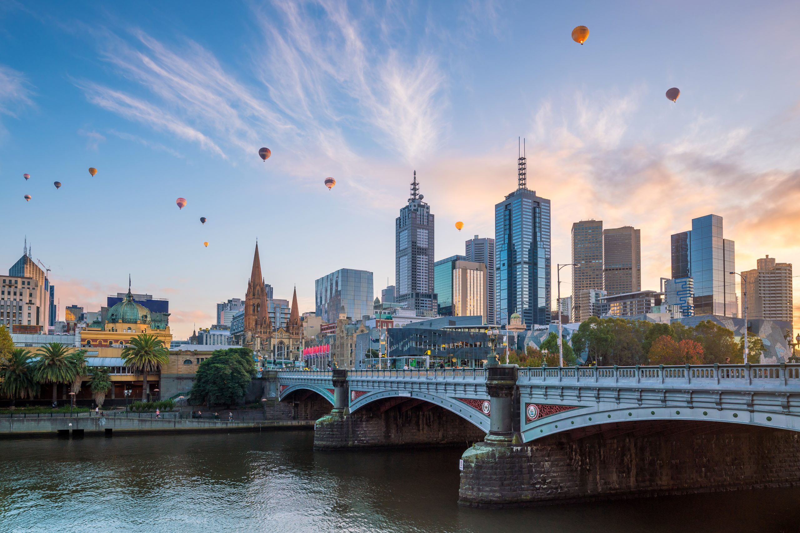Hot Air Balloons over the Melbourne city skyline at twilight in Australia.